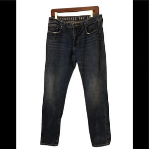 Distressed slim fit tapered jean